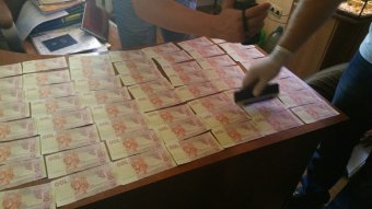 На получении 9 тыс. гривен взятки задержали следователя горотдела милиции Ильичевска (фото)