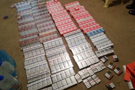 В частных домах Раздельнянского района нашли 15 тысяч пачек сигарет и более 250 литров нелегального алкоголя (фото, видео)